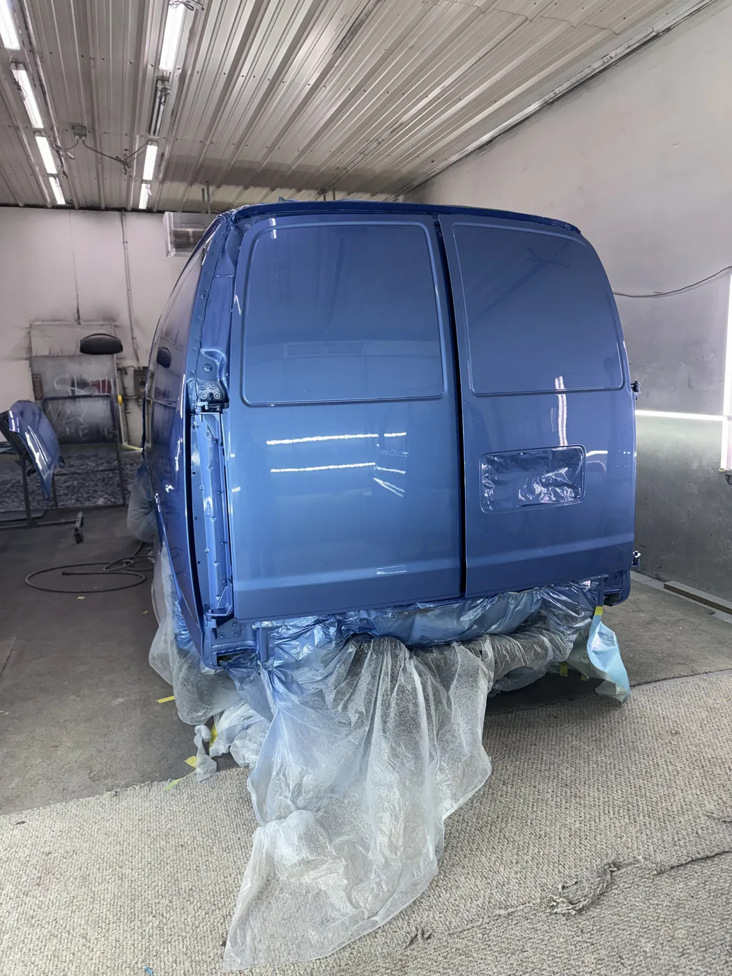 Blue van rear doors masked for paint