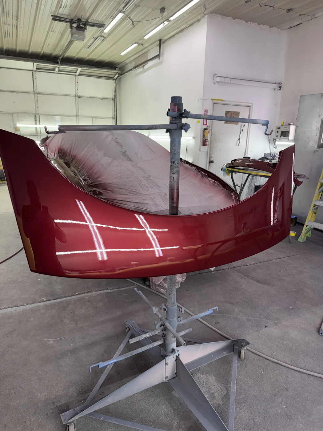 Burgundy vehicle panel set up for refinishing