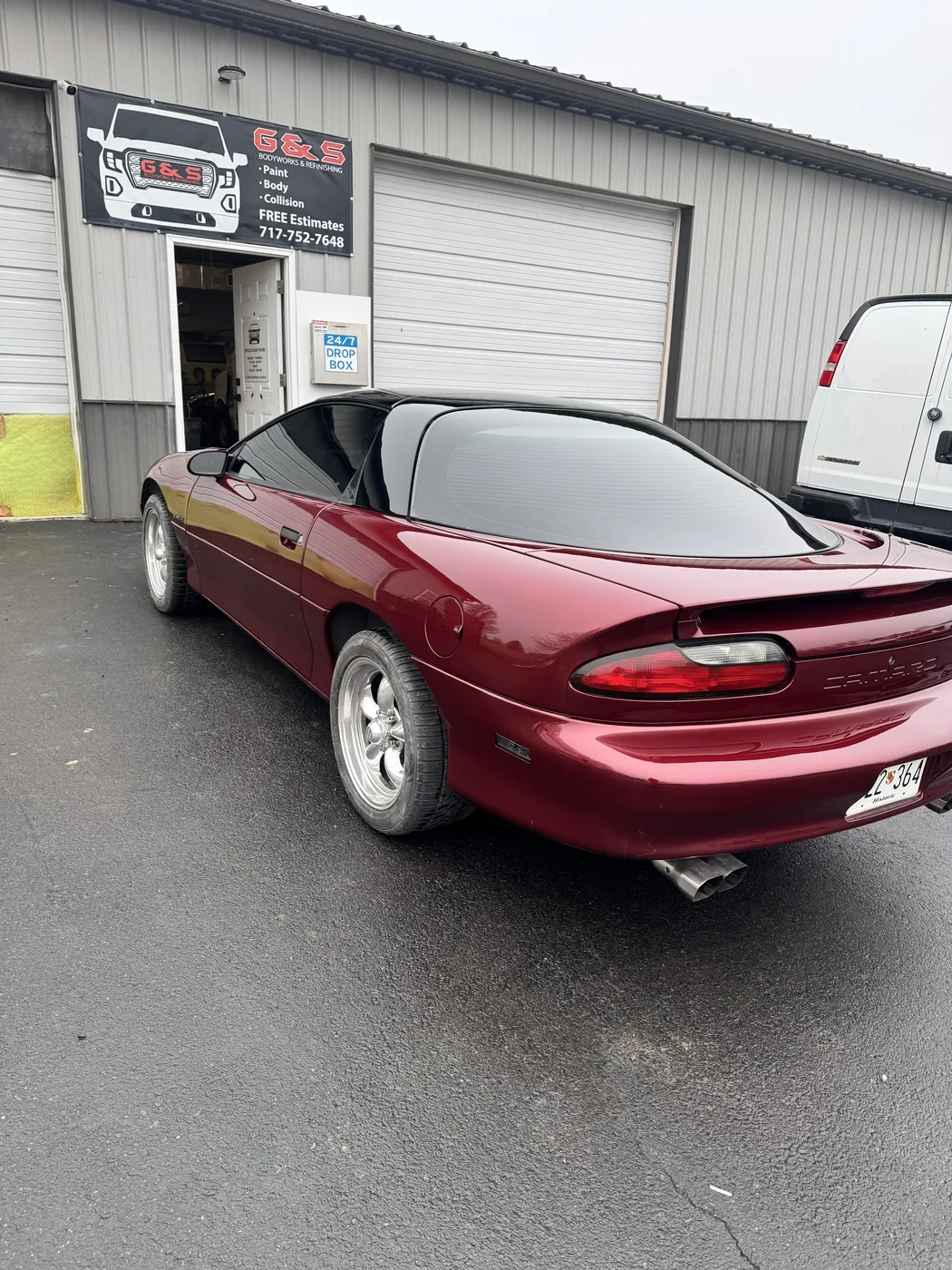Red Camaro photographed from the rear after bodywork