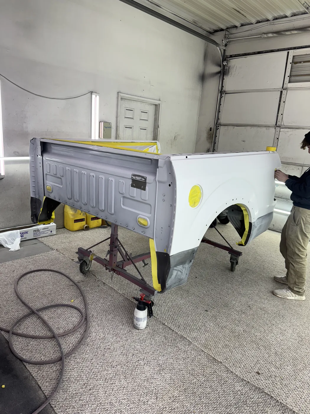Truck bed in primer inside the shop